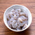 Uncooked raw shrimp in bowl of ice